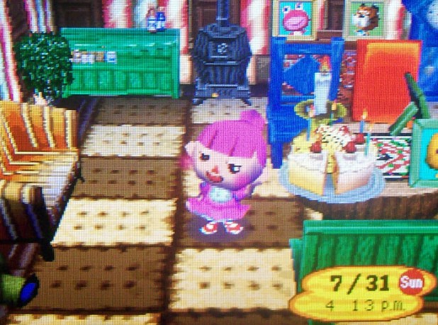 Bell blushing next to her cake