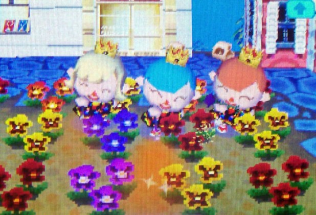 Three butterfly princesses setting off sparklers in the pansy garden